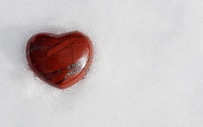 Stone heart on cold white snow