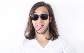 Man with glasses sticking out his tongue