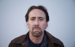 Actor Nicolas Cage on a gray background