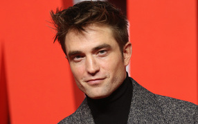 Actor Robert Pattinson on a red background