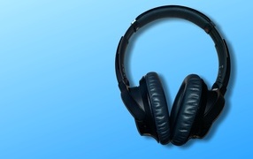 Large black headphones on a blue background