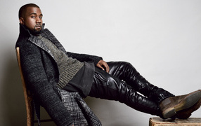 Rapper Kanye West sits on a chair
