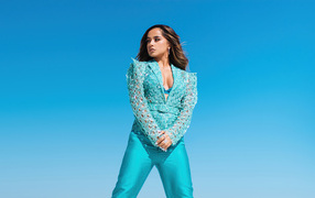 Singer Becky G on a blue background