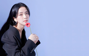 Singer Kim Ji-soo with a flower on a gray background