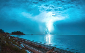 Lightning strike in stormy sky over the sea