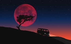 The red moon lights up the road and the lone tree