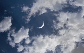 Young moon in white clouds