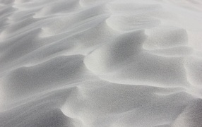 Waves on white sand in the desert