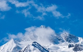 Blue sky over snow covered mountains
