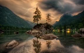 Thunderstorm lightning over a cold mountain lake
