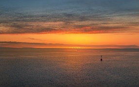 Bright orange sunset on the sea horizon