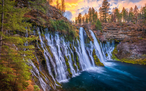 Rapid waterfall flows into the lake, California