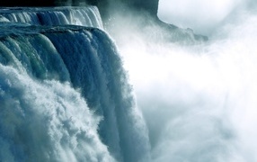The raging Niagara Falls flows down from the mountains