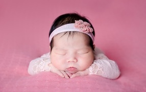 Cute sleeping Asian girl with headband
