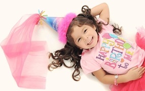 Happy little girl in birthday costume