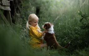 Little girl befriends a puppy