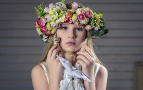 Little girl with a beautiful wreath on her head