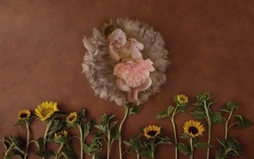 Маленькая девочка с цветами подсолнуха