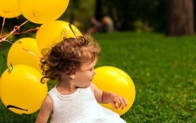 Little girl with yellow balls