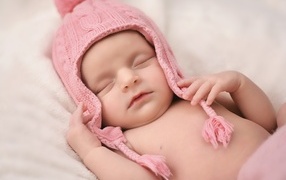 Pink hat on the head of a sleeping baby