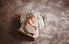 Sleeping newborn baby in the crib