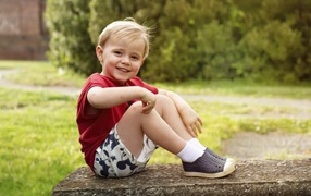 Smiling little boy in a red t-shirt