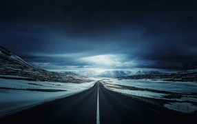 Long road with snowy outskirts