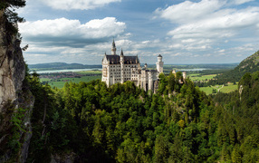 Neuschwanstein Castle in dense thickets of trees, Germany