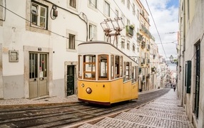 A tram rides along the street of Lisbon, Portugal