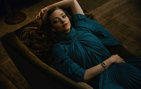 Actress Amanda Seyfried in a dress lies on the couch