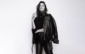 Actress Ana de Armas in a black jacket on a white background