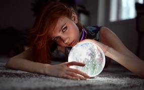 Girl with piercings holding a magic ball