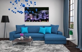 Большой синий диван в комнате в стиле модерн