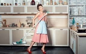 Retro girl in a dress in the kitchen