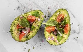 Avocado with salad and spices on the table