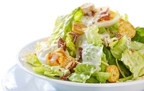 Caesar salad on a large white plate