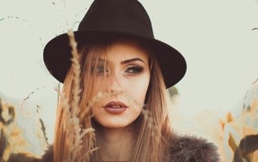Serious girl in a black hat