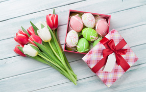 Easter eggs in a box with a bouquet of tulips