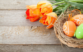 Painted eggs with orange tulips for Easter 2024
