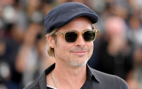 Actor Brad Pitt in a cap and glasses