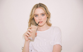 Beautiful blonde Kathryn Newton with a drink in her hands
