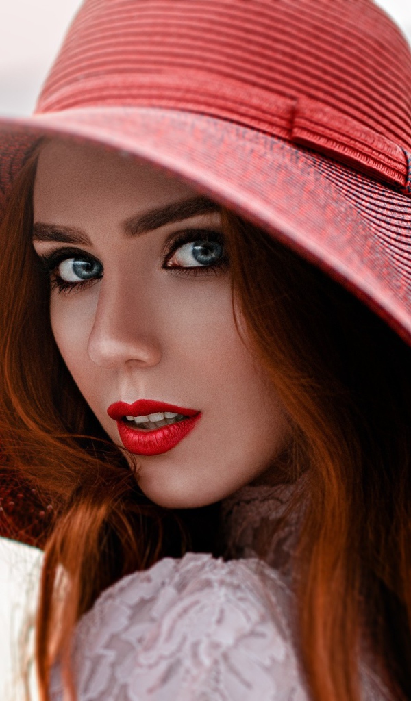 Red-haired girl in a big red hat