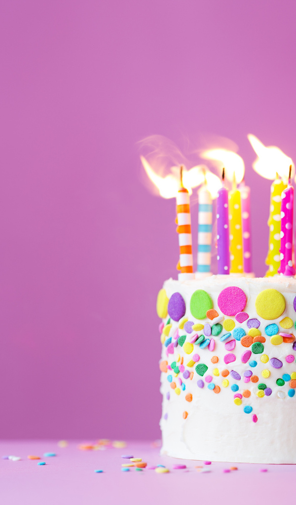 Birthday cake with candles on a lilac background