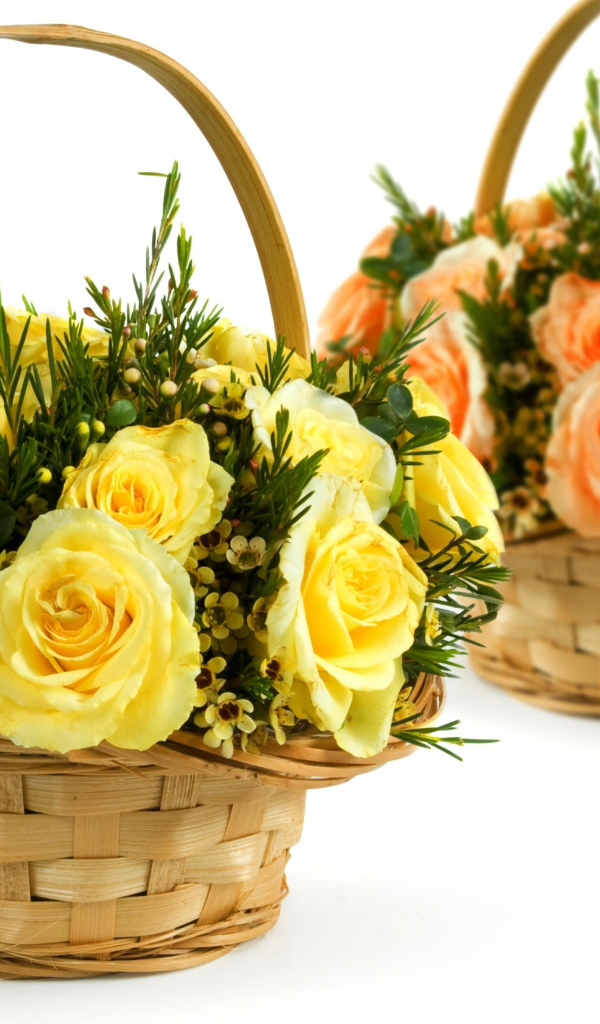 Two baskets with yellow and orange roses on a white background