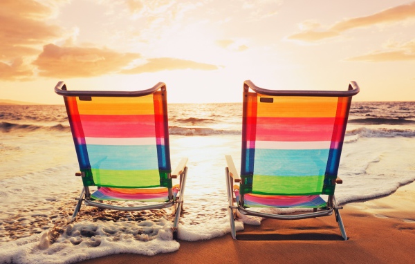 Deck chairs made of transparent plastic on the beach