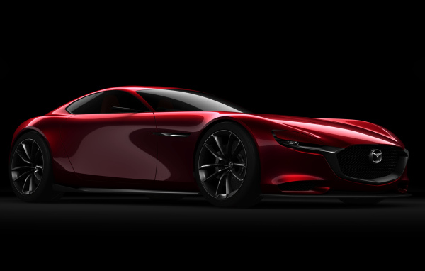 Красный спортивный автомобиль Mazda RX Vision Concept на черном фоне