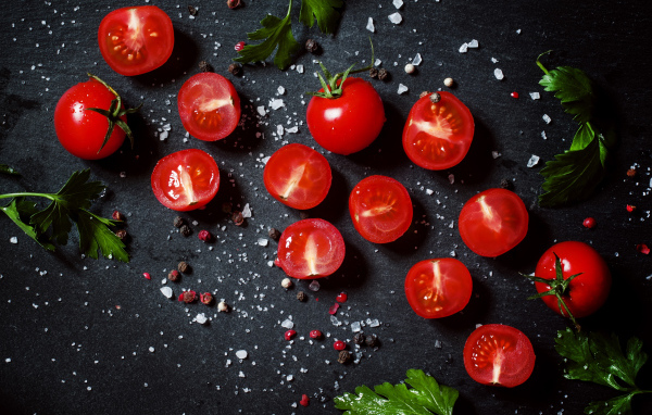 Tomatoes on the table with parsley and spices