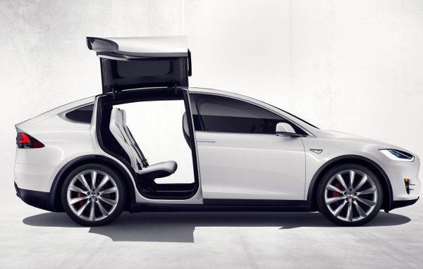 White Tesla electric car with open doors