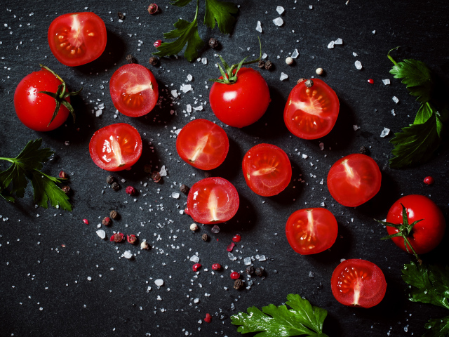 Tomatoes on the table with parsley and spices