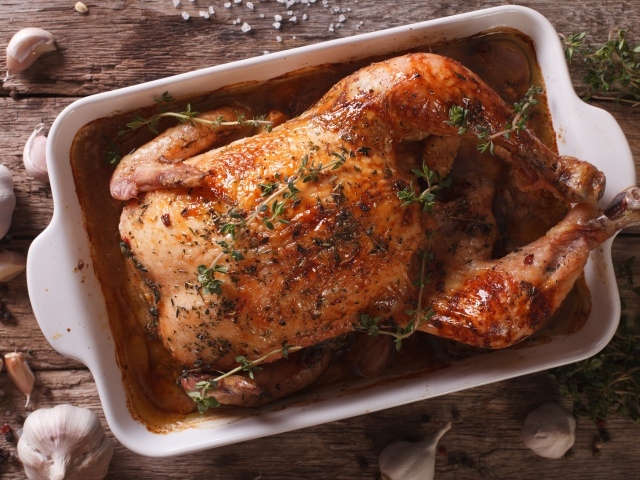 Baked appetizing chicken with spices on the table